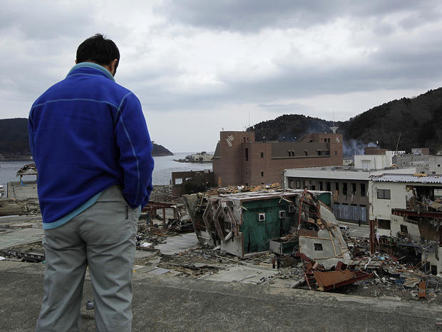A survivor surveys damage in Onagawa, Iwate prefecture 