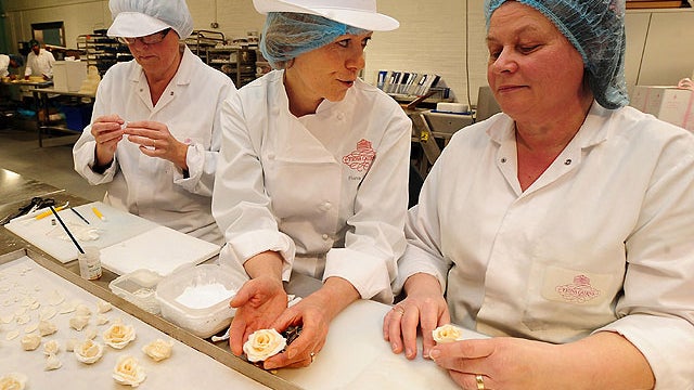 Cake designer Fiona Cairns, center, with Mary Doody, right, and Diane Pallet make decorations for the royal wedding cake, Fleckney, England Thursday, March 24, 2011. Cairns has been commissioned by Prince William and Kate Middleton to create a multi-tiere 