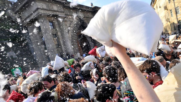 Feathers fly in mass pillow fights in cities 
