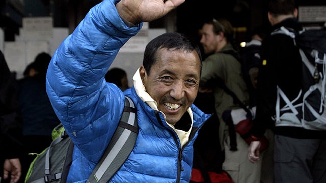 Nepalese veteran mountaineer Apa, also known as Apa Sherpa, who has climbed Everest a record 20 times, waves to supporters at the airport before leaving for Mount Everest on an expedition to clear away tons of trash left on the world's highest peak, in Ka 