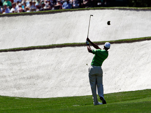Tiger Woods hits a shot from the third hole  