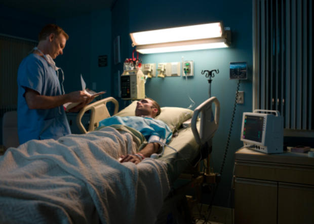 Doctor examining patient in hospital room 
