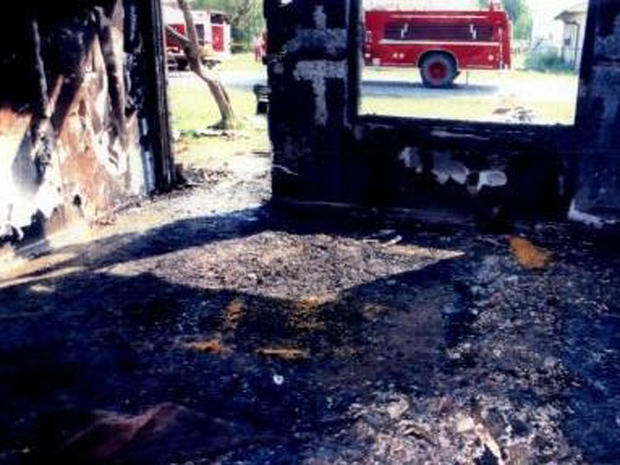 A picture of the scorched living room of the Davis'  Somerville, Texas home where six people were murdered. 