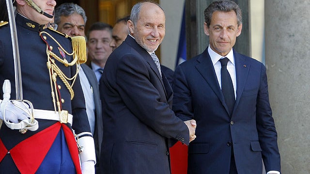 France's President Nicolas Sarkozy, rigth, leaves with Libyan National Transitional Council's Mustapha Abdeljalil after a meeting at the Elysee Palace; in Paris, April, 20, 2011.  