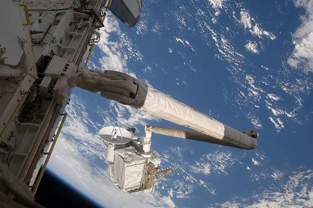 The remote manipulator system (RMS) arm of the Space Shuttle Endeavour is seen here transferring the Integrated Cargo Carrier (ICC) to the International Space Station on July 19, 2009. The ICC is an unpressurized flat bed pallet used to deliver supplies f 
