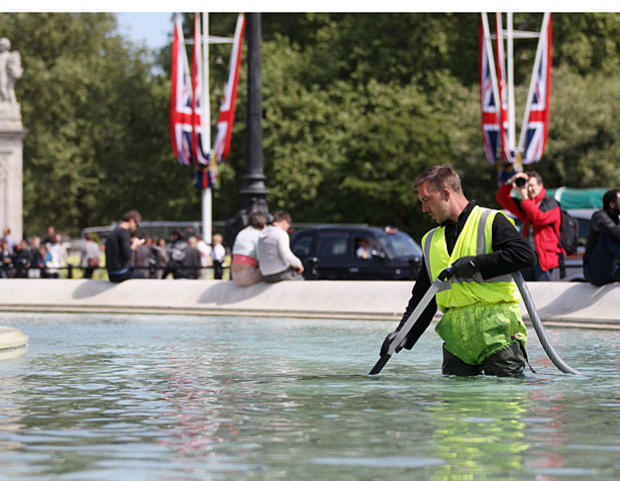 A workman cleans the fountains in the Queen Victoria Memorial in front of Buckingham Palace on April 27, 2011, in London. 