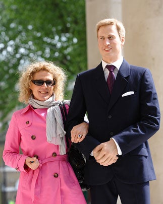 A woman slides her finger into a replica of the engagement ring affixed to the forearm of an art work entitled "Engagement"; a life-sized wax model of Britain's Prince William by U.S. artist Jennifer Rubell, in London, on April 28, 2011.  