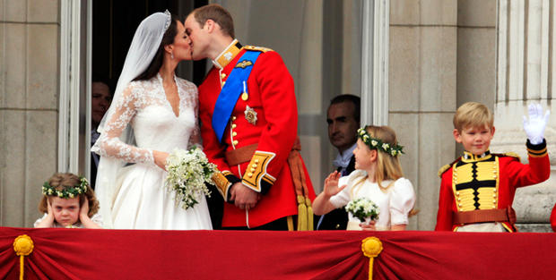Britain's Prince William kisses his wife Kate, Duchess of Cambridge on the balcony of Buckingham 