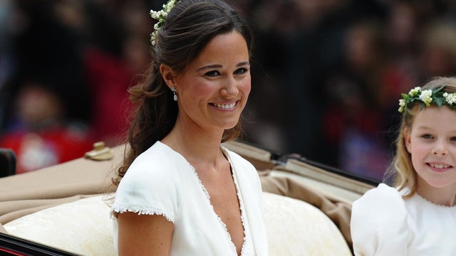 Maid of honour Philippa Middleton smiles as the travels in a Semi-State Landau in London after the wedding service for Britain's Prince William and Kate, Duchess of Cambridge, on April 29, 2011. AFP PHOTO / PAUL ELLIS (Photo credit should read PAUL ELLIS/ 