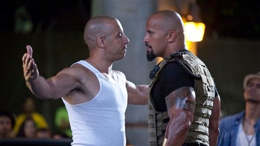 Publicity image released by Universal Pictures shows Vin Diesel, left, and Dwayne Johnson in scene from "Fast Five." 