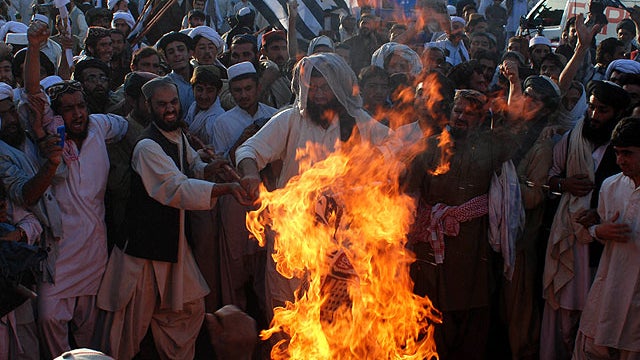 Angry supporters of Pakistani religious party Jamiat Ulema-e-Islam burn representation of the United States during a rally to condemn the killing of Osama bin Laden in Quetta, Pakistan on, May 2, 2011.  