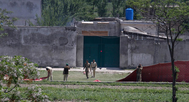 Pakistan army troops remove canvas screens from outside a house, where al Qaeda leader Osama bin Laden was caught and killed in Abbottabad, Pakistan. 