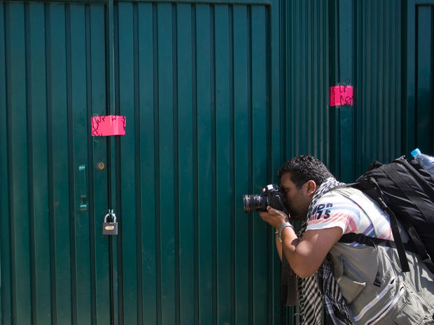 A photographer takes a photo of the sealed gate into the compound where  al Qaeda leader Osama bin Laden was caught and killed in Abbottabad, Pakistan 