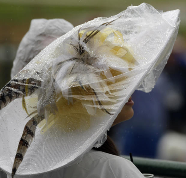 Maria Bermudez covers her hat with plastic before the 137th Kentucky Derby horse race at Churchill Downs Saturday, May 7, 2011, in Louisville, Ky.  