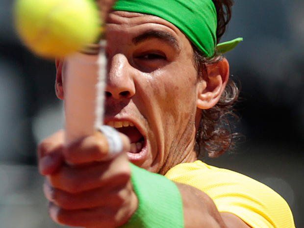 Rafael Nadal returns the ball  