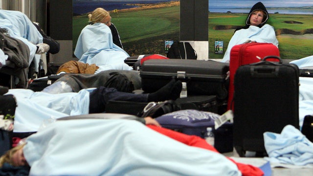 Travelers sleeping at Edinburgh Airport 