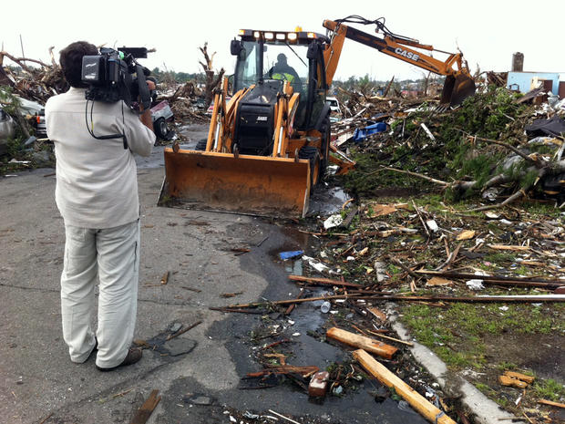 A bulldozer begins to clean up the damage in Joplin.   