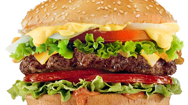 Close up of golden roast chicken  and thyme. 