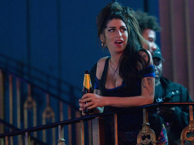 Amy Winehouse watches The Libertines perform on Aug. 25, 2010, in London.  