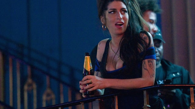Amy Winehouse watches The Libertines perform on Aug. 25, 2010, in London.  