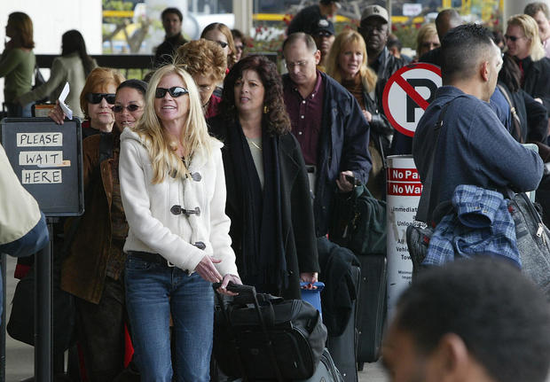  Passengers wait in line to have their bags inspected at Los Angeles International Airport (LAX) 