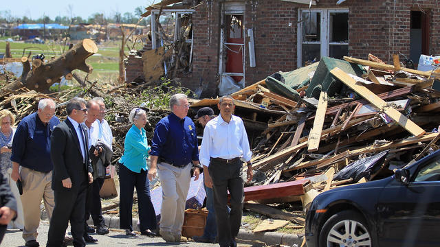 President Obama walks with Missouri Governor Jay Nixon as they greet people during a visit twister-decimated Joplin, Mo. Sunday 