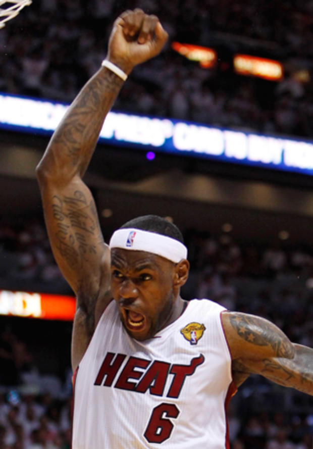 LeBron James reacts after dunking the ball  