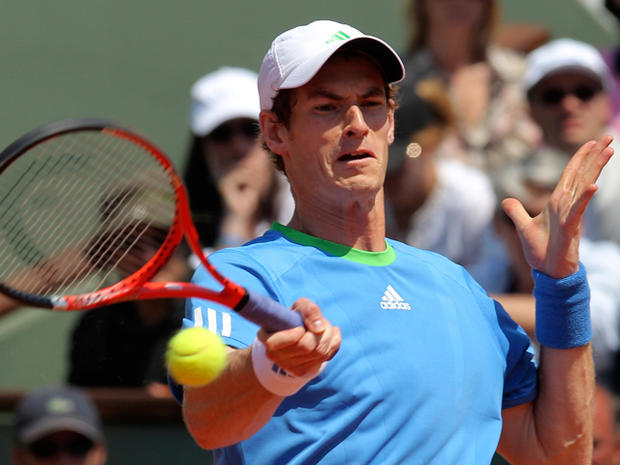 Andy Murray returns the ball to defending champion Spain's Rafael Nadal 