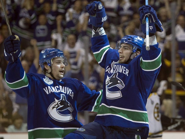Alex Burrows celebrates with teammate Mason Raymond  
