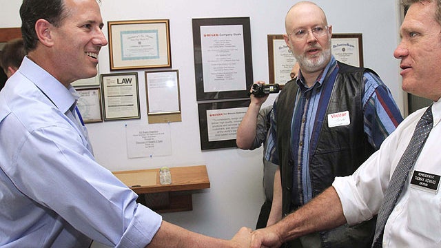 In this May 31, 2011, file photo former Pennsylvania Sen. Rick Santorum, left, shakes hands with New Hampshire state Rep. Thomas Howard before touring Rugar Firearms in Newport, N.H.  