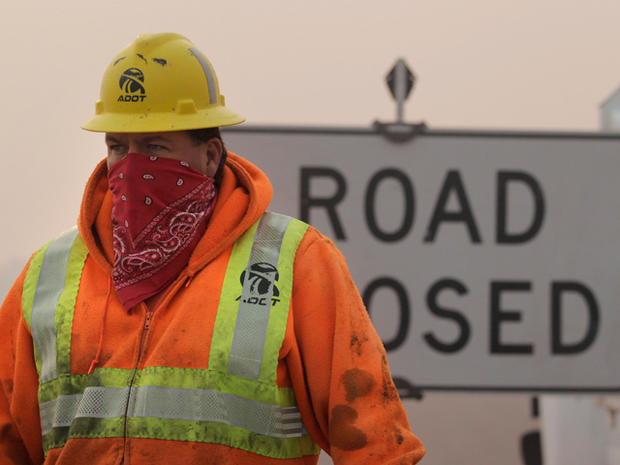 Arizona Department of Transportation wears a mask as he works at a check point 