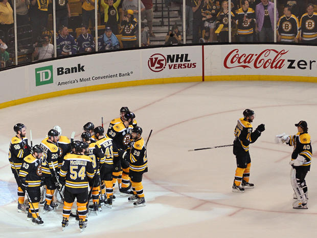 Boston Bruins celebrate after defeating the Vancouver Canucks 