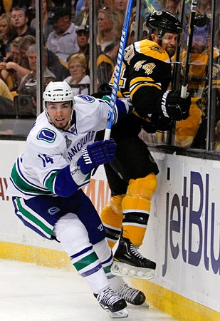Alex Burrows checks Dennis Seidenberg 