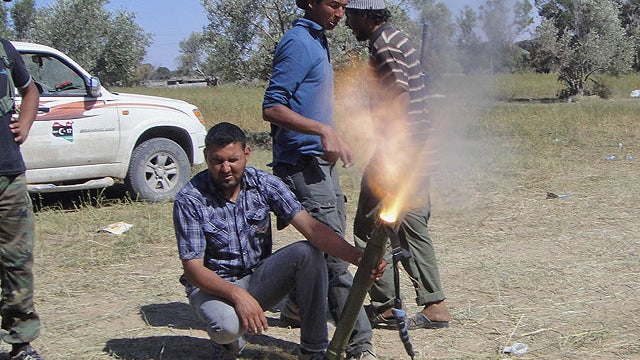 Rebel fighters fire their mortars towards pro-Moammar Gadhafi forces at the front line of Dafniya, west of Misrata, Libya, June 15, 2011.  