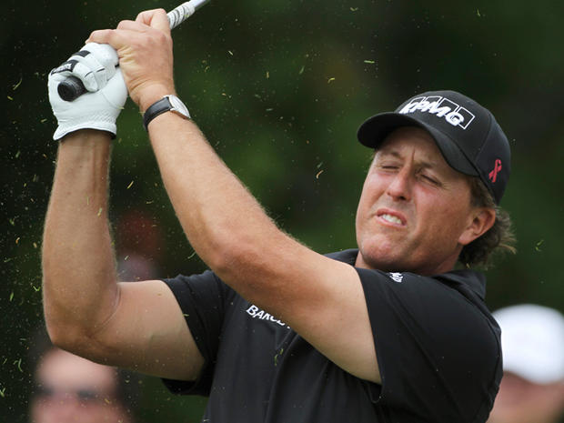 Phil Mickelson reacts to his shot  