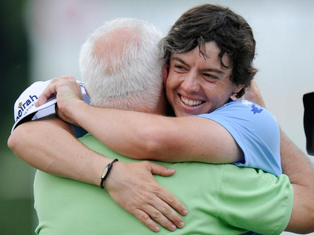Rory McIlroy hugs his father Gerry on the 18th green 