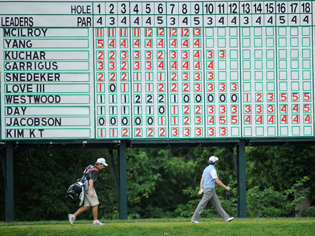 Rory McIlroy looks up at a leaderboard 