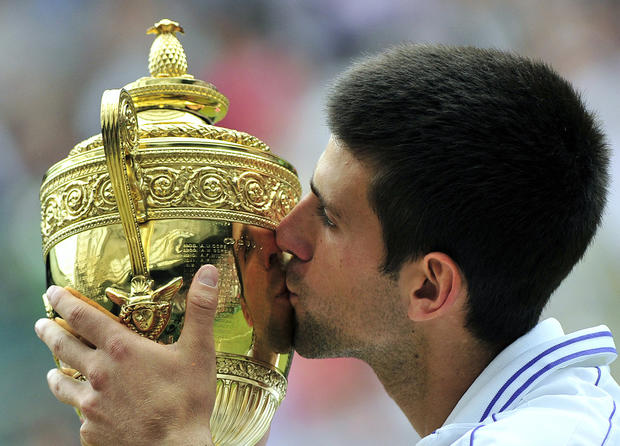 Novak Djokovic kisses the trophy 