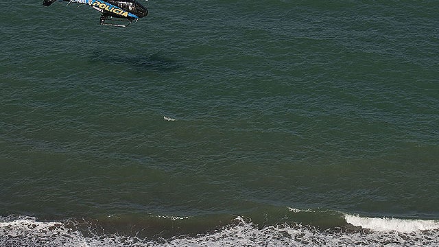 A state police helicopter searches the waters of the Gulf of California for survivors of a capsized fishing boat near San Felipe, Mexico, July 4, 2011.  