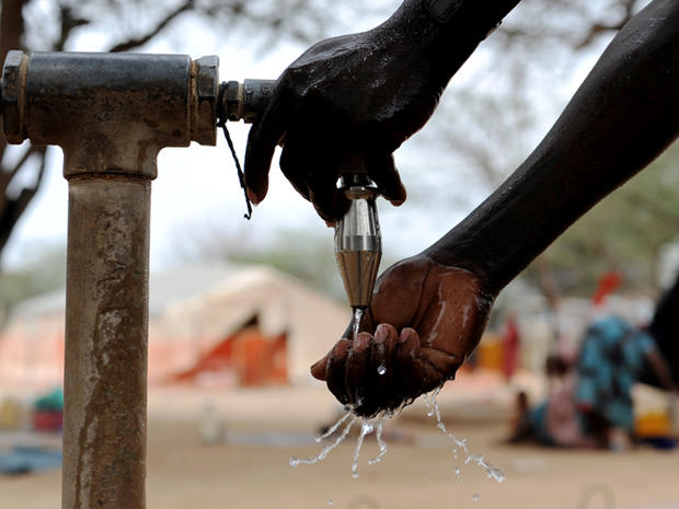 Somali man accesses a water point at the Dadaab refugee camp 