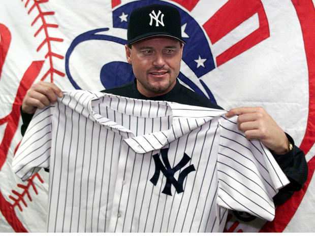 Roger Clemens holds up his new uniform 