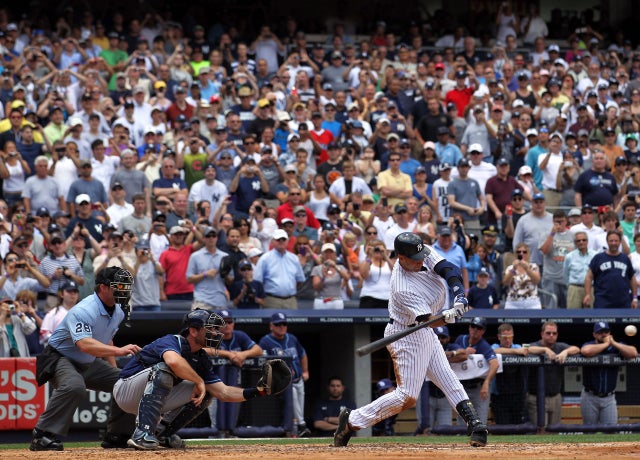 Derek Jeter follows through on a solo home run for his 3,000 
