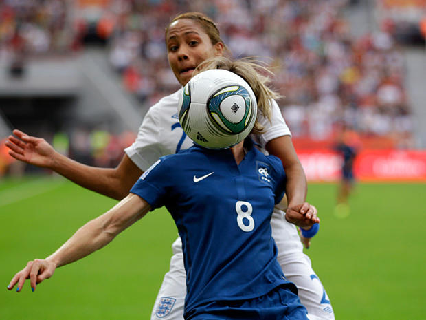 Sonia Bompastor and Alex Scott challenge for the ball  