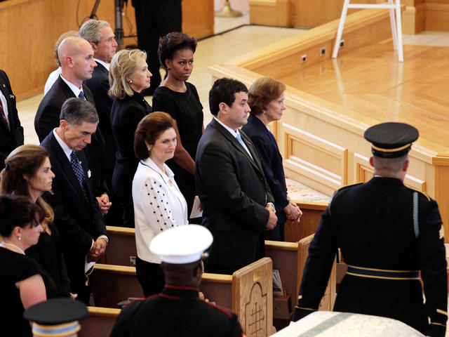 Mike Ford is comforted by an unidentifed family member during the funeral  for his mother and former first lady Betty Ford at St. Margaret's Episcopal  Church in Palm Desert, California on July