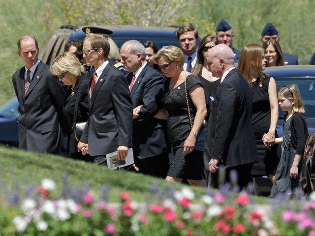 Mike Ford is comforted by an unidentifed family member during the funeral  for his mother and former first lady Betty Ford at St. Margaret's Episcopal  Church in Palm Desert, California on July