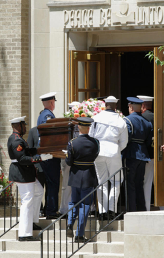 Mike Ford is comforted by an unidentifed family member during the funeral  for his mother and former first lady Betty Ford at St. Margaret's Episcopal  Church in Palm Desert, California on July