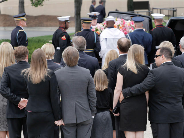 Mike Ford is comforted by an unidentifed family member during the funeral  for his mother and former first lady Betty Ford at St. Margaret's Episcopal  Church in Palm Desert, California on July