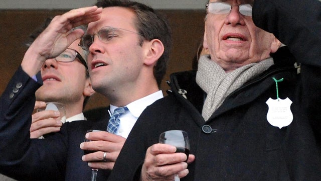James Murdoch, left, and Rupert Murdoch are seen during the Cheltenham Festival at Cheltenham, England, March 18, 2010. 