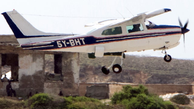 A plane takes off from Mogadishu's airport Nov. 26, 2009, with two freelance journalists, one from Canada and the other from Australia, who were freed after 15 months in captivity in Somalia. 