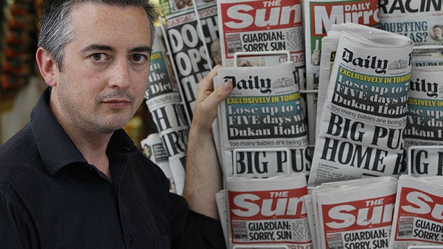 Michael Taggart, former journalist at News International news paper, The Sun next to a news stand in London, July 15, 2011.  